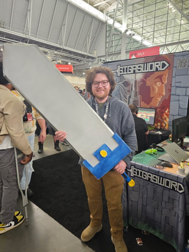 Zack holding the GigaSword at PAX East 2025