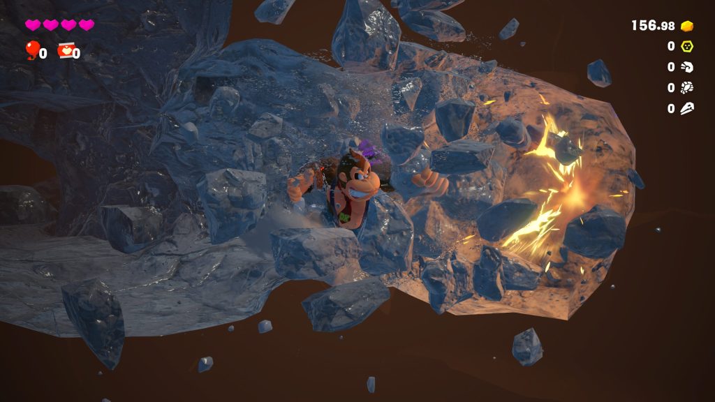 A gameplay screenshot with health and other data points int he corner while Donkey Kong tunnels through rocks. 