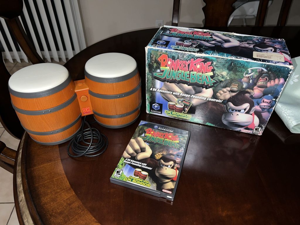 A photo of a vintage Donkey Kong Junglebeat box with bongo controllers for sale on a table