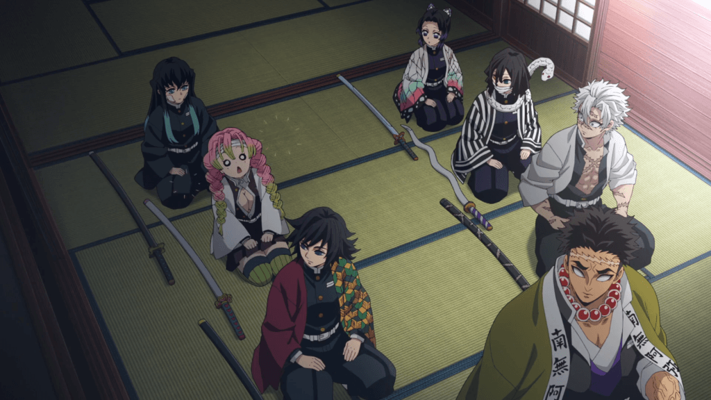 A screenshot of the anime Demon Slayer where several characters sit in a training studio with swords