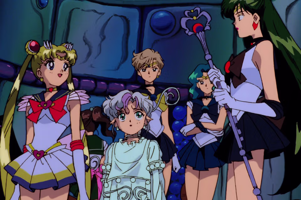 A screenshot of the main characters of the anime Sailor Moon in their uniforms discussing