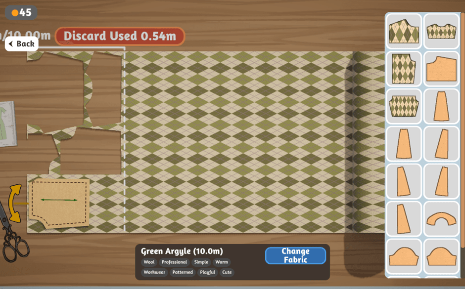 Dressmaker indie game - screenshot of the player cutting into Green Argyle fabric