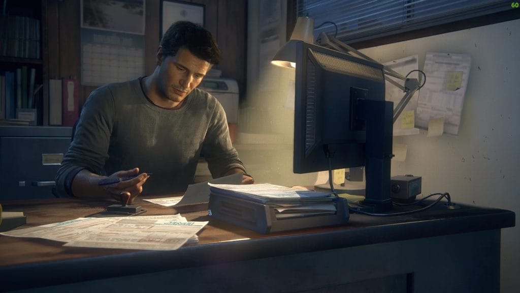 Screenshot from Uncharted 4: A Thief's End, where Nathan Drake is doing some research at his desk - the perfect analogy for someone researching hidden achievements before diving into a video game