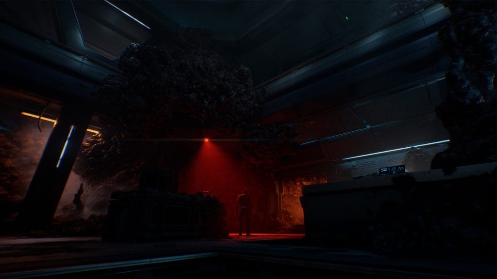 In a Directive 8020 review, a screenshot of the game showing one person standing in eerie red lighting