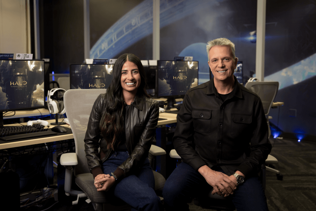 A photo of Xbox CEO Asha Sharma and Chief Content Officer Matt Booty, both looking and smiling into the camera