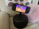 A photo of the Steam Deck on a Mechanism Gaming Pillow on an armchair and a pink pillow.
