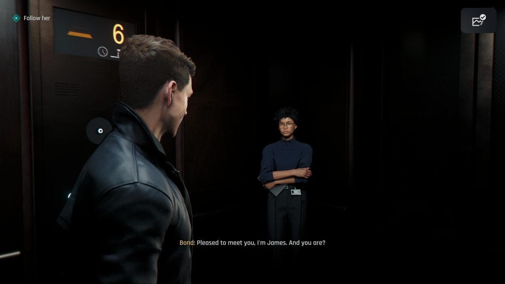 A screenshot from 007 First Light (2026, IO Interactive) showing James Bond saying "Pleased to meet you, I'm James. And you are?" to a young Black woman in an elevator who stares at him with arms crossed. This image is featured in a piece analyzing the role of Moneypenny in James Bond films, books,and video games.