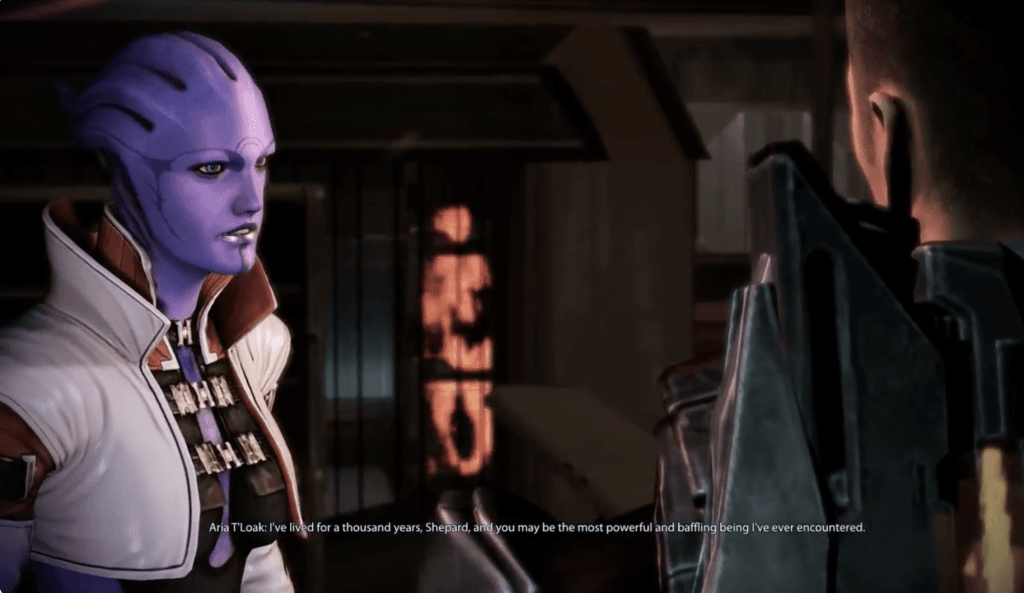 A screenshot from the mixed/neutral end of Mass Effect 3: Omega DLC in which Aria T'Loak, a purple alien, says to Shepard, "I've lived for a thousand years, Shepard, and you may be the most powerful and baffling being I've ever encountered." This is featured in an op-ed comparing the Citadel and Afterlife as hubs in the original Mass Effect trilogy. 