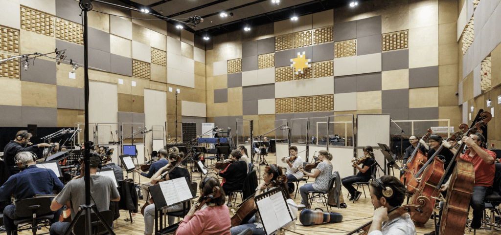 A photo of the Budapest Art Orchestra recording music, featured in a piece discussing their work with composer Raphael Benjamin Meyer for original soundtrack (OST) for The Mermaid Mask, an indie video game. 