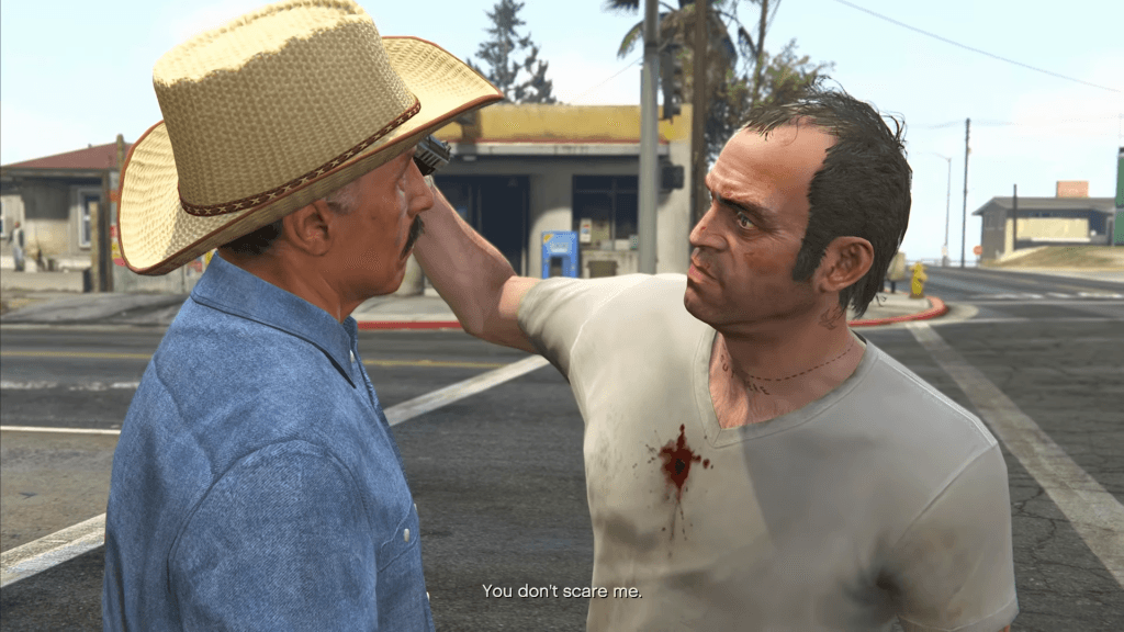 Grand Theft Auto V - photo of Trevor Philips pointing a gun at Manuel's face in Minute Man Blues