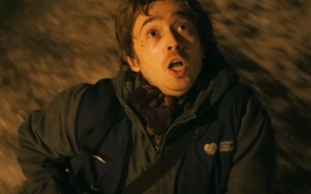 Resident Evil (2026 film) - Bryan looking up at something off screen, with a look of horror in his face